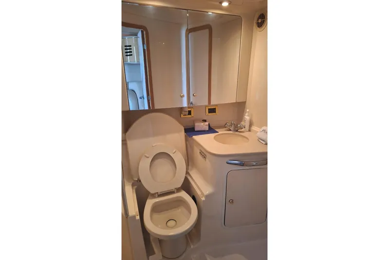 2000 Sea Ray 460 Sundancer @ Ixtapa Yacht Photos Pics Bathroom interior of 2000 Sea Ray 460 Sundancer yacht, featuring toilet and sink.