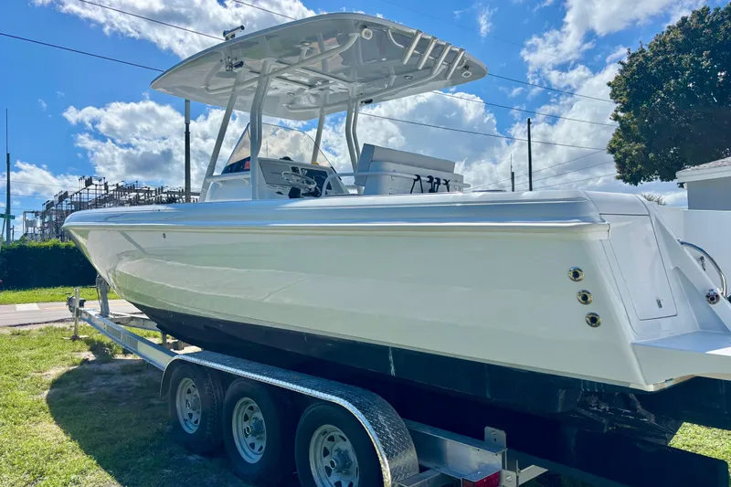  Yacht Photos Pics 2008 Intrepid 327 Center Console boat on trailer under blue sky.