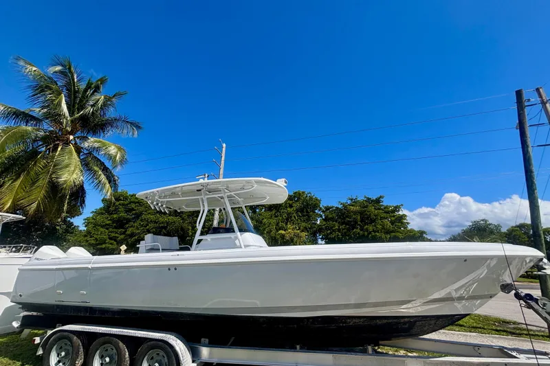  Yacht Photos Pics 2008 Intrepid 327 Center Console boat on trailer under clear blue sky.