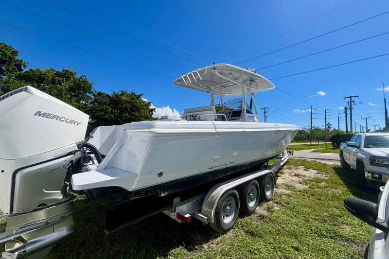  Yacht Photos Pics 2008 Intrepid 327 Center Console boat on trailer with Mercury engines, under clear blue sky.