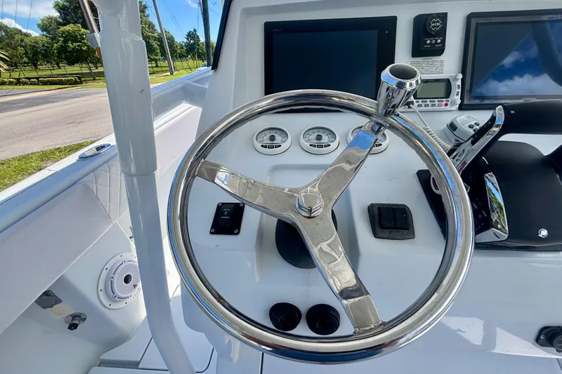  Yacht Photos Pics 2008 Intrepid 327 Center Console helm with steering wheel and navigation controls.