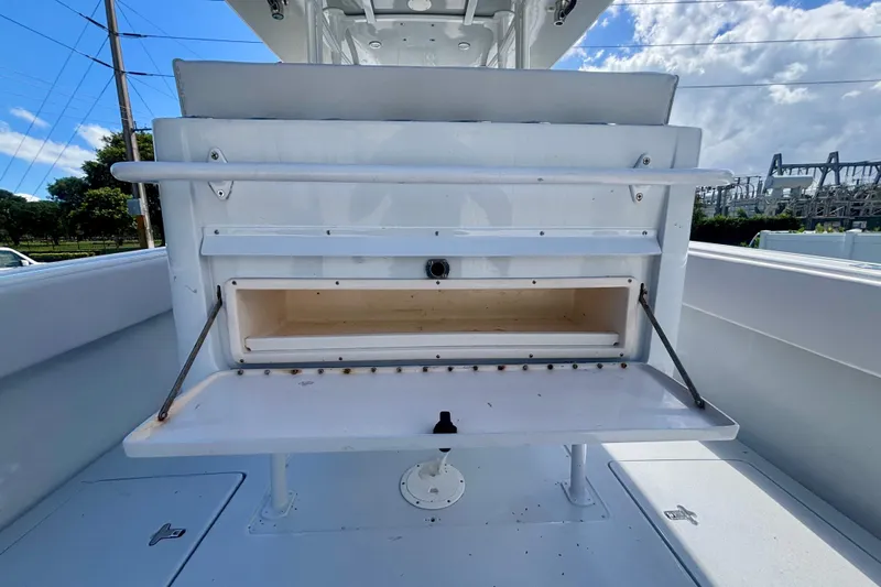 Yacht Photos Pics 2008 Intrepid 327 Center Console boat interior with open storage compartment under blue sky.