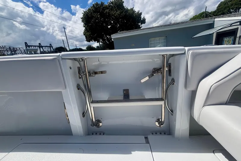  Yacht Photos Pics 2008 Intrepid 327 Center Console boat ladder and seating detail under a cloudy sky.