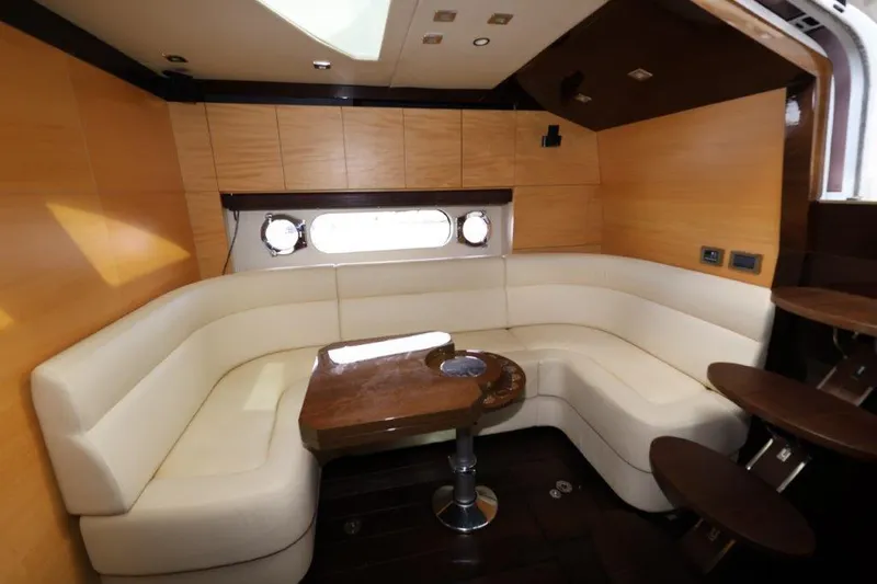 Yacht Photos Pics Luxurious interior of 2014 Sunseeker San Remo yacht with elegant seating and wooden table.