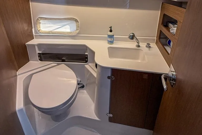  Yacht Photos Pics 2024 Beneteau Antares 9 bathroom with modern fixtures and compact design.