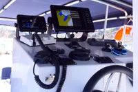 Control panel of 2025 Olbap TR12 Open boat with navigation screens and communication devices.