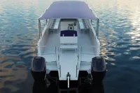2025 Olbap TR12 Open boat with dual engines on calm water.