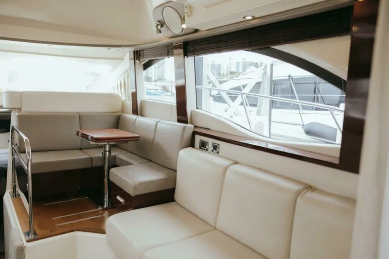 The Green Squirrel Yacht Photos Pics Luxurious interior of 2010 Sea Ray 390 Sedan Bridge yacht with plush seating and wooden accents.