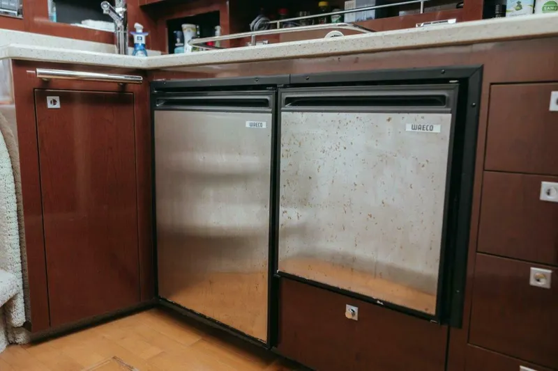 The Green Squirrel Yacht Photos Pics Galley kitchen in 2010 Sea Ray 390 Sedan Bridge with stainless steel appliances.