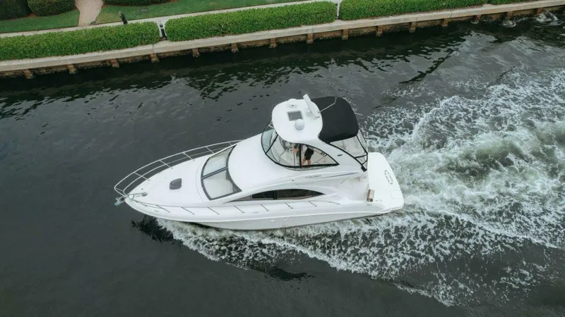 The Green Squirrel Yacht Photos Pics Aerial view of 2010 Sea Ray 390 Sedan Bridge cruising on a canal.