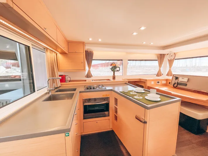  Yacht Photos Pics Modern kitchen interior of 2019 Lagoon 450 s yacht with sleek countertops and appliances.