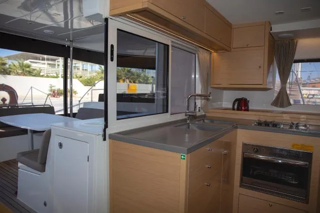  Yacht Photos Pics Modern kitchen interior of 2019 Lagoon 450 s catamaran with sleek design and appliances.