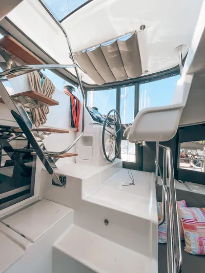  Yacht Photos Pics Interior view of 2019 Lagoon 450 s catamaran with modern helm and seating area.