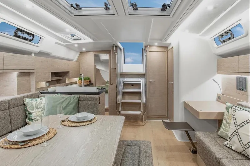  Yacht Photos Pics Luxurious interior of 2020 Hanse 458 yacht with modern dining and seating area.