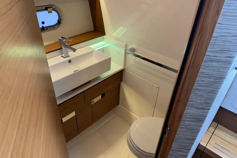  Yacht Photos Pics Luxurious bathroom in 2025 Tiara Yachts 38 LS, featuring modern sink and toilet.