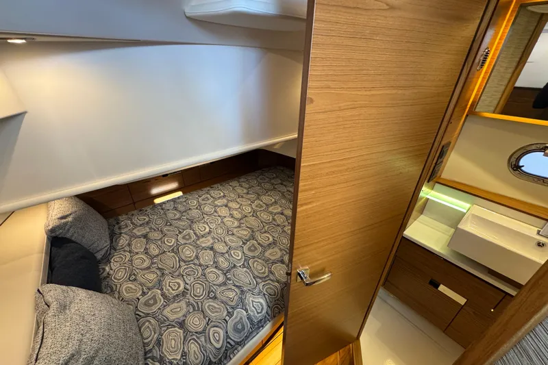  Yacht Photos Pics Luxurious cabin interior of 2025 Tiara Yachts 38 LS with modern design and cozy bedding.