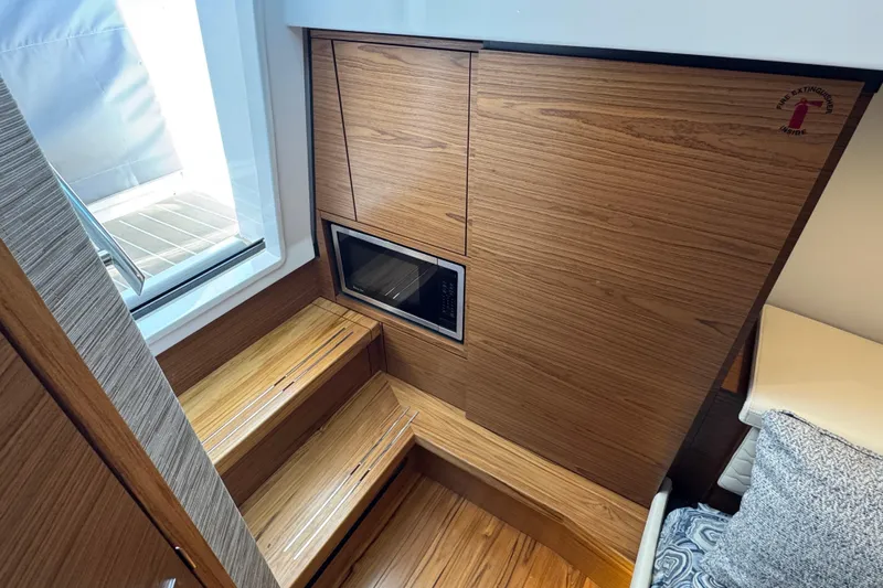  Yacht Photos Pics Interior of 2025 Tiara Yachts 38 LS with wooden stairs and built-in microwave.