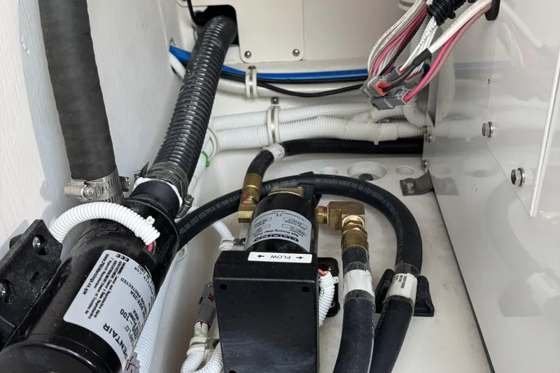  Yacht Photos Pics Engine compartment of 2025 Tiara Yachts 38 LS, showcasing hoses and wiring.