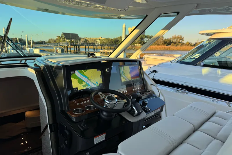  Yacht Photos Pics 2025 Tiara Yachts 38 LS helm with advanced navigation system, docked at marina.