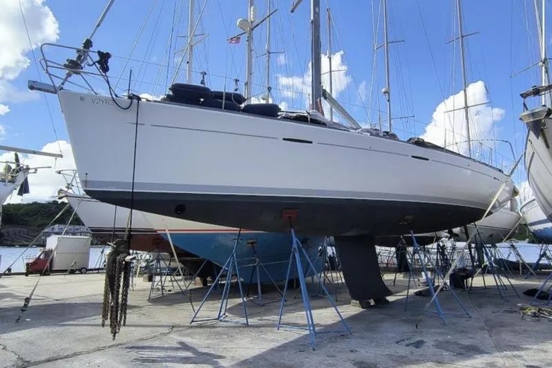 Unbound Yacht Photos Pics 2001 Beneteau First 47.7 sailboat on stands, dockside, under clear blue sky.