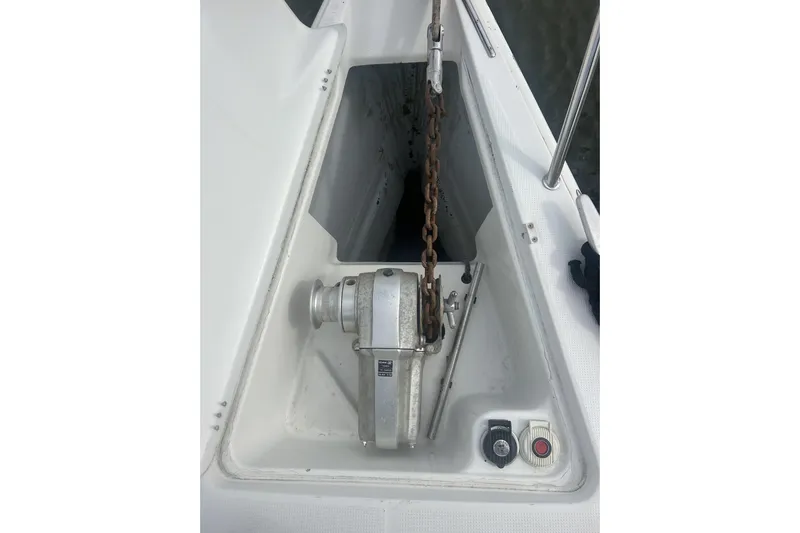 Unbound Yacht Photos Pics Anchor windlass on 2001 Beneteau First 47.7 sailboat deck, featuring chain and controls.
