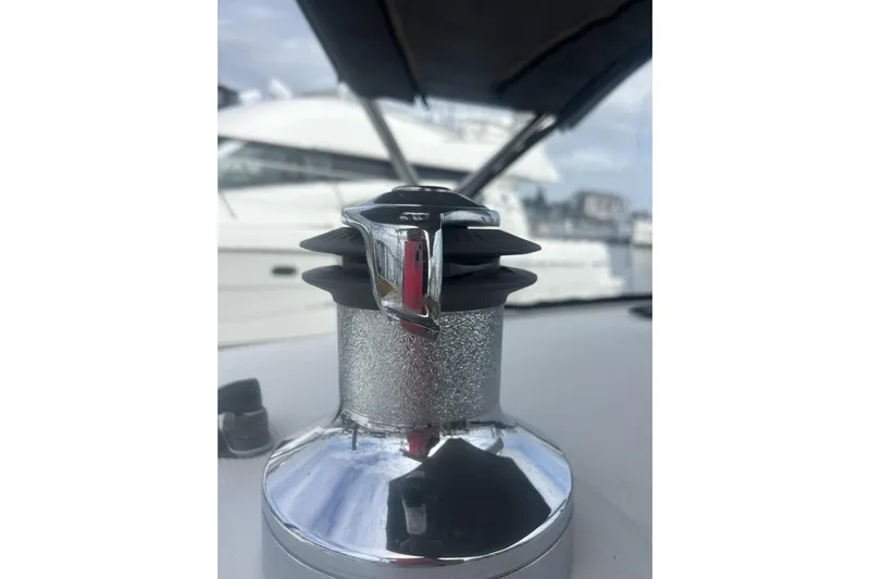 Unbound Yacht Photos Pics Close-up of a winch on a 2001 Beneteau First 47.7 sailboat, with blurred background.