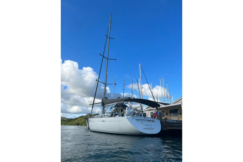 Unbound Yacht Photos Pics Sailing yacht Beneteau First 47.7, 2001 model, docked under a clear blue sky.