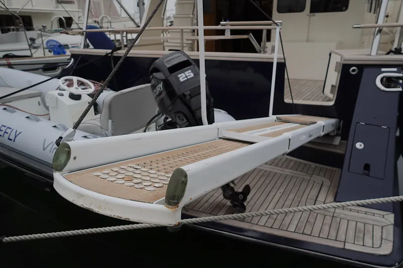 Defly Yacht Photos Pics Boarding platform of a 2009 Marlow 61E yacht with outboard motor and tender.