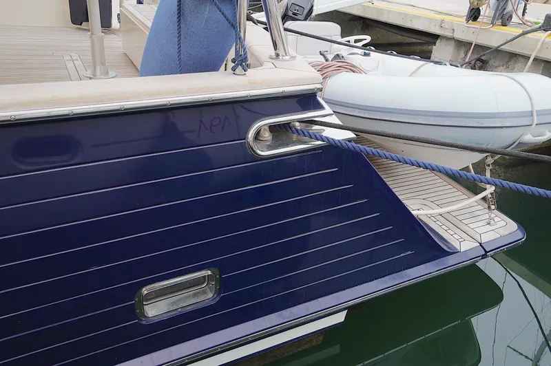 Defly Yacht Photos Pics Stern view of 2009 Marlow 61E yacht docked with tender boat.