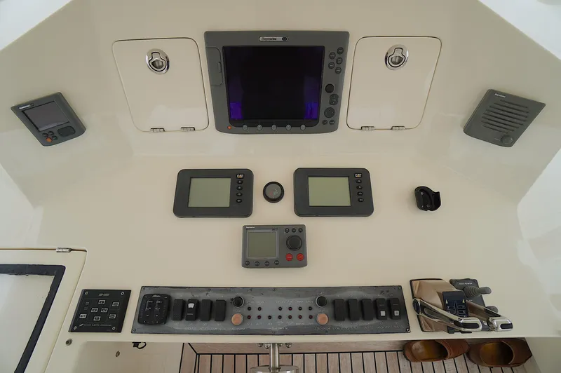 Defly Yacht Photos Pics Control panel of a 2009 Marlow 61E yacht with navigation and communication equipment.