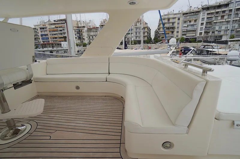 Defly Yacht Photos Pics Luxurious seating area on a 2009 Marlow 61E yacht, docked in a marina.