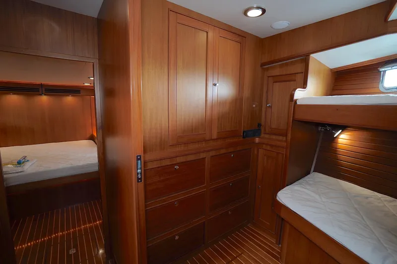Defly Yacht Photos Pics Luxurious wooden interior of 2009 Marlow 61E yacht with cozy bunk beds.