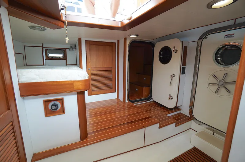 Defly Yacht Photos Pics Interior of 2009 Marlow 61E yacht with wooden flooring and nautical decor.