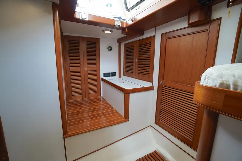 Defly Yacht Photos Pics Interior of 2009 Marlow 61E yacht with wooden cabinetry and flooring.
