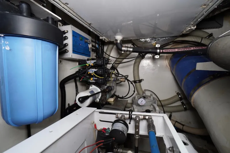 Defly Yacht Photos Pics Engine room of a 2009 Marlow 61E yacht with various mechanical components.