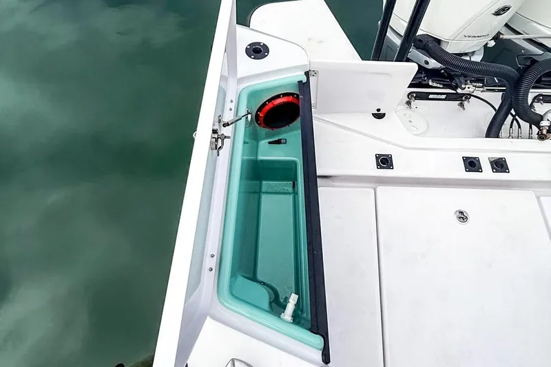  Yacht Photos Pics 2023 Axopar 37 XC Cross Cabin boat deck with storage compartment and engine view.