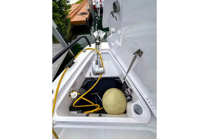  Yacht Photos Pics 2023 Axopar 37 XC Cross Cabin storage compartment with equipment and yellow rope.