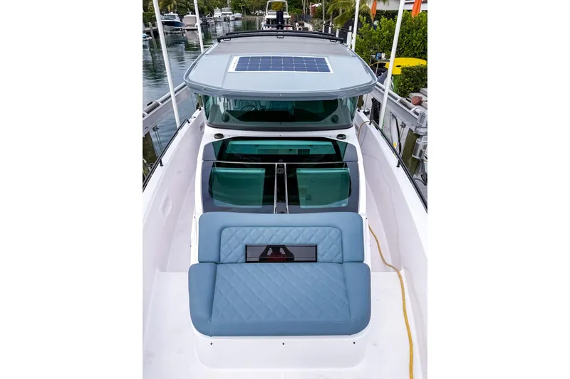  Yacht Photos Pics 2023 Axopar 37 XC Cross Cabin boat with blue seating and solar panel roof.