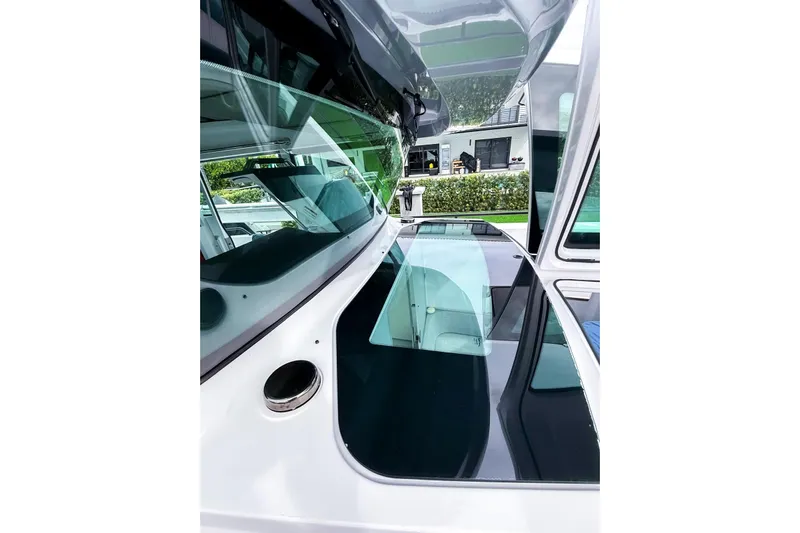  Yacht Photos Pics 2023 Axopar 37 XC Cross Cabin boat with sleek glass windows and modern design.