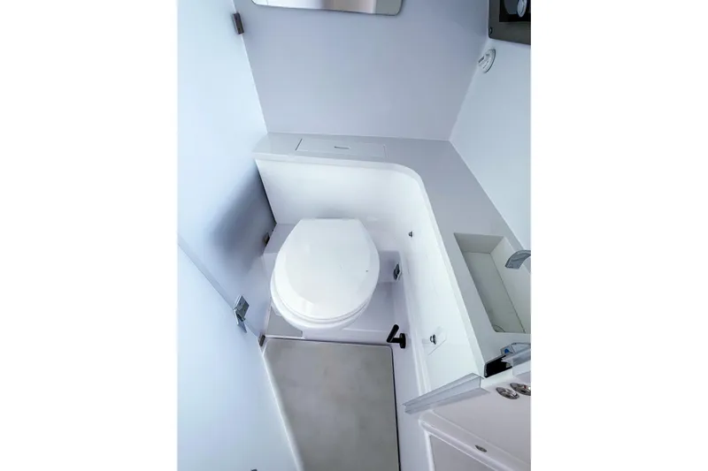  Yacht Photos Pics 2023 Axopar 37 XC Cross Cabin bathroom with modern white fixtures and compact design.
