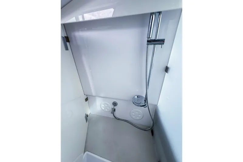  Yacht Photos Pics Shower area in 2023 Axopar 37 XC Cross Cabin boat, featuring modern fixtures.