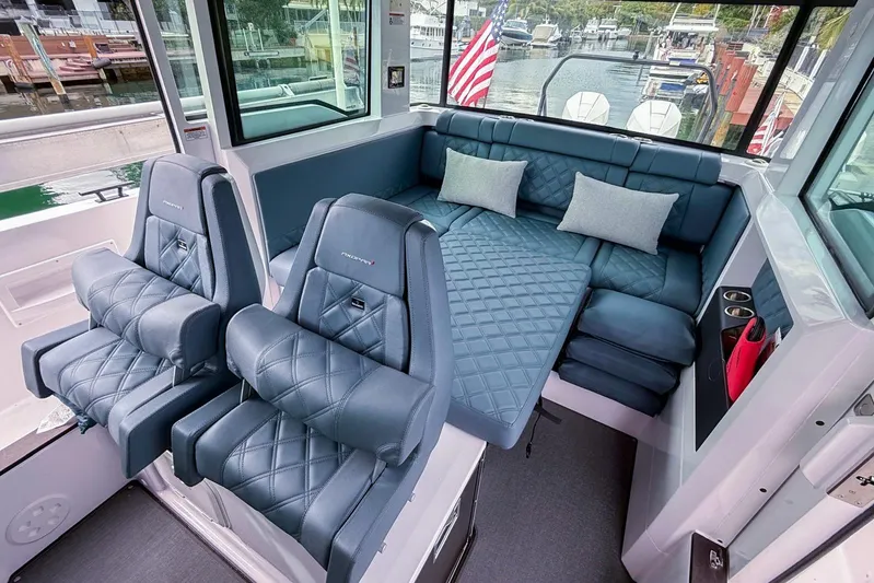  Yacht Photos Pics 2023 Axopar 37 XC Cross Cabin interior with luxurious seating and convertible lounge area.
