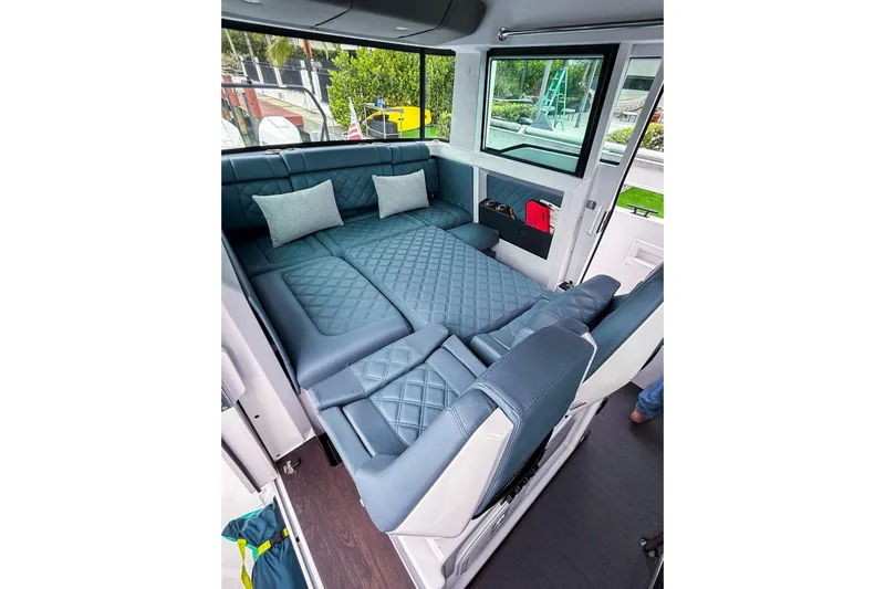  Yacht Photos Pics Luxurious interior of 2023 Axopar 37 XC Cross Cabin with plush seating and cushions.