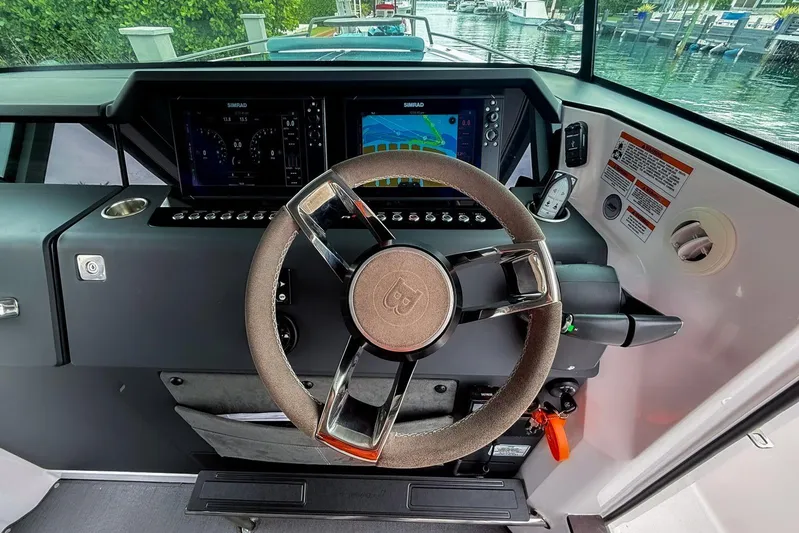  Yacht Photos Pics 2023 Axopar 37 XC Cross Cabin helm with modern steering and navigation displays.