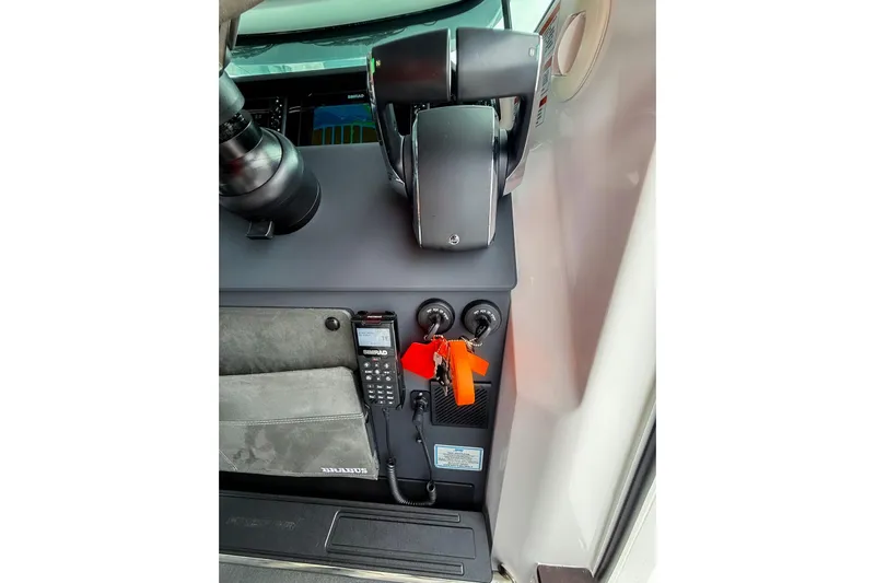  Yacht Photos Pics Control panel of 2023 Axopar 37 XC Cross Cabin with navigation equipment and keys.