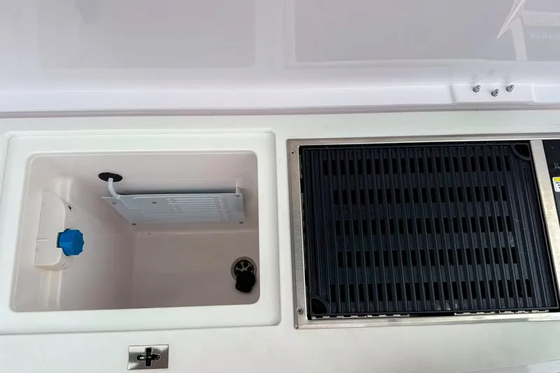  Yacht Photos Pics 2023 Axopar 37 XC Cross Cabin interior storage and grill area.