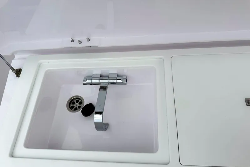  Yacht Photos Pics 2023 Axopar 37 XC Cross Cabin sink with modern chrome faucet.