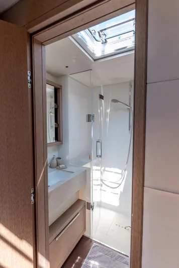  Yacht Photos Pics 2024 Lagoon SIXTY 5 yacht bathroom with skylight, modern shower, and sleek design.