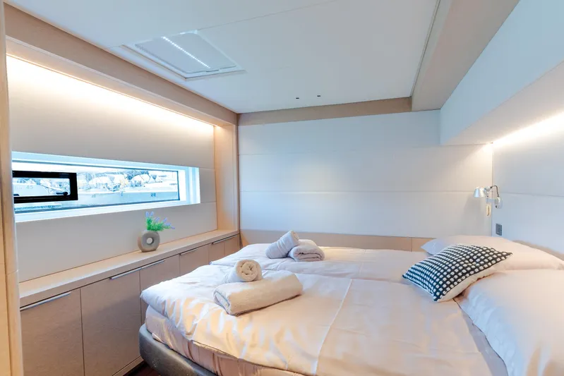  Yacht Photos Pics Luxurious bedroom interior of 2024 Lagoon SIXTY 5 yacht with modern design and natural lighting.