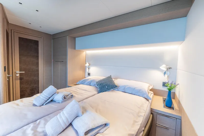 Yacht Photos Pics Luxurious bedroom interior of 2024 Lagoon SIXTY 5 yacht with modern design and cozy bedding.